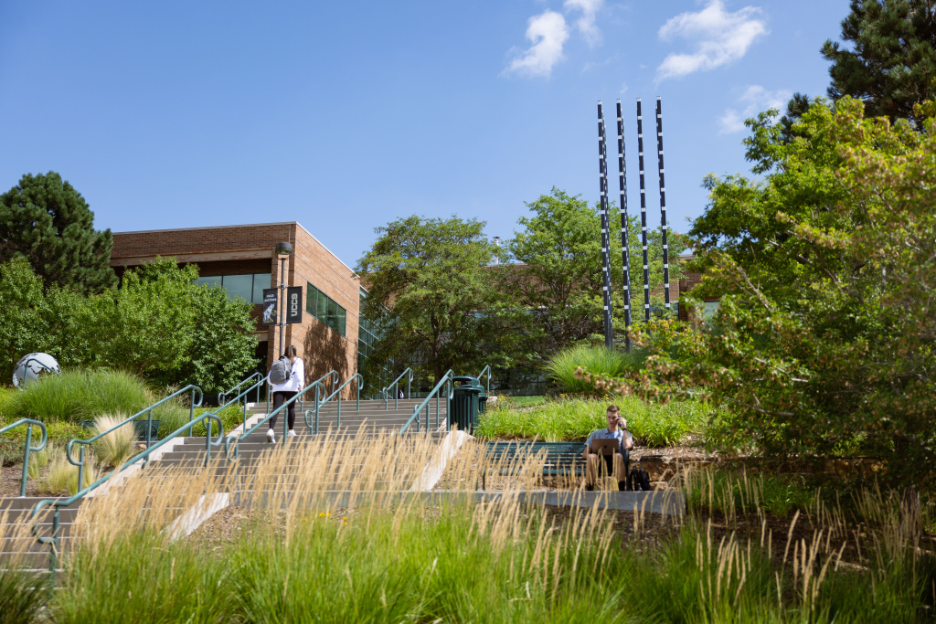 student sitting outside of the engineering building