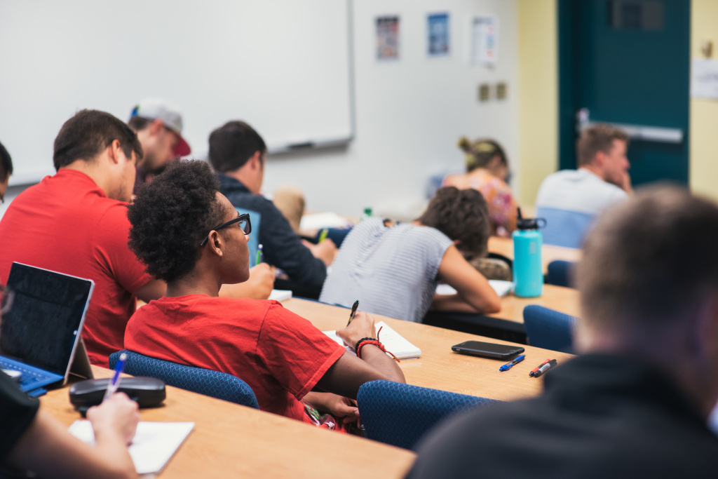 students sitting in a lecture classroom taking notes