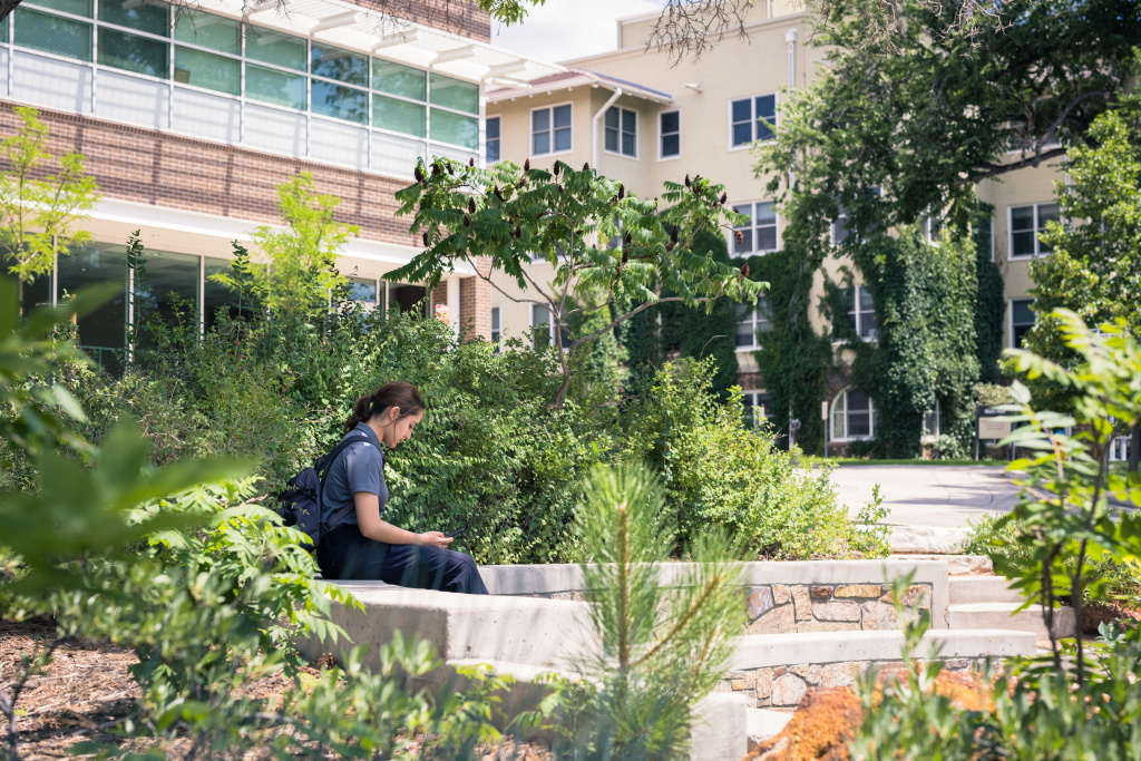 student sitting outside of Dwire hall