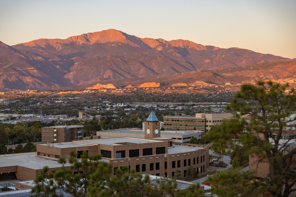 campus buildings with mountains in the background