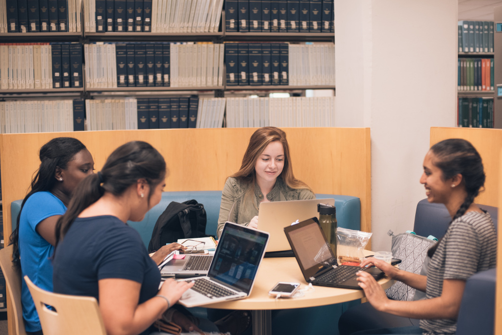 a group of students working together on a project in the library