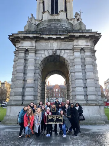 Students in Ireland under large arch.