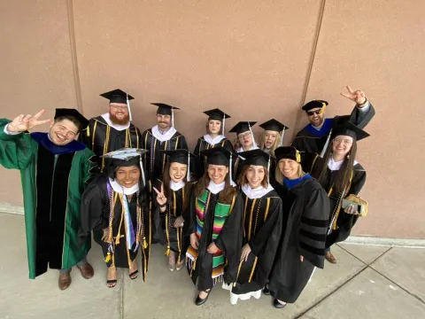 Group of graduates smiling.